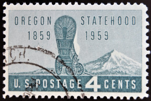 UNITED STATES OF AMERICA - CIRCA 1959: A Stamp printed in USA shows the covered Wagon and Mount Hood Oregon Statehood Centenary circa 1959